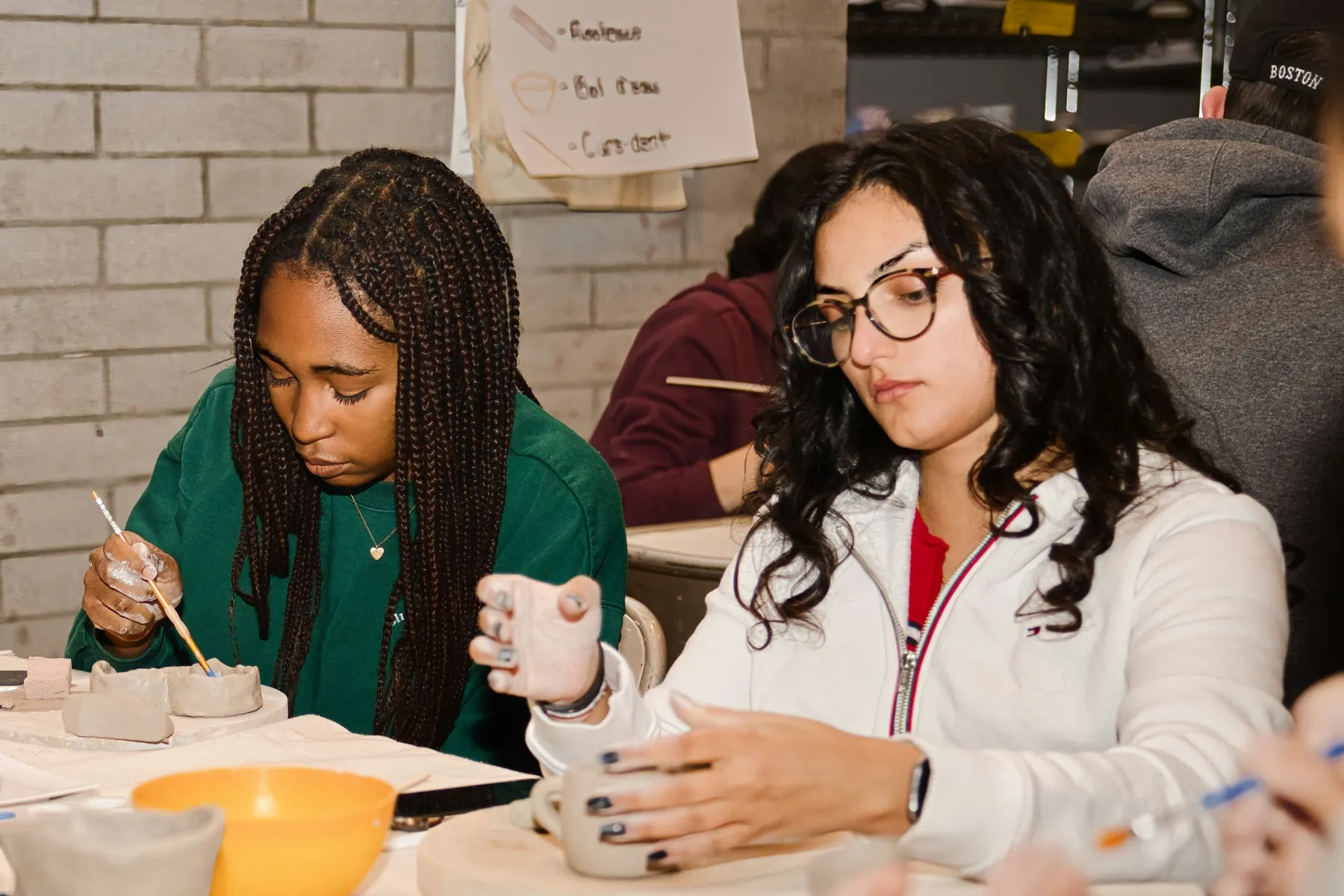 Students working on a hands-on activity at a table.