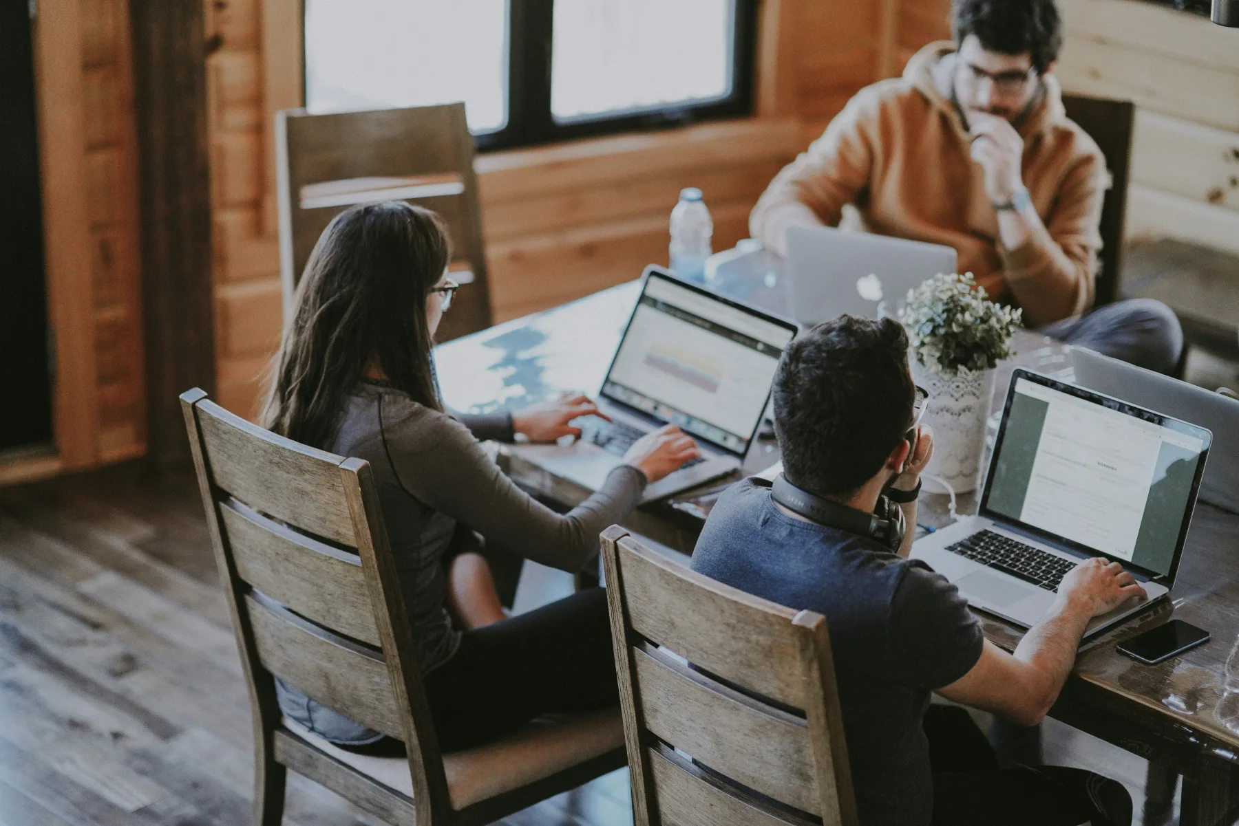 A small team discussing work together at a table.